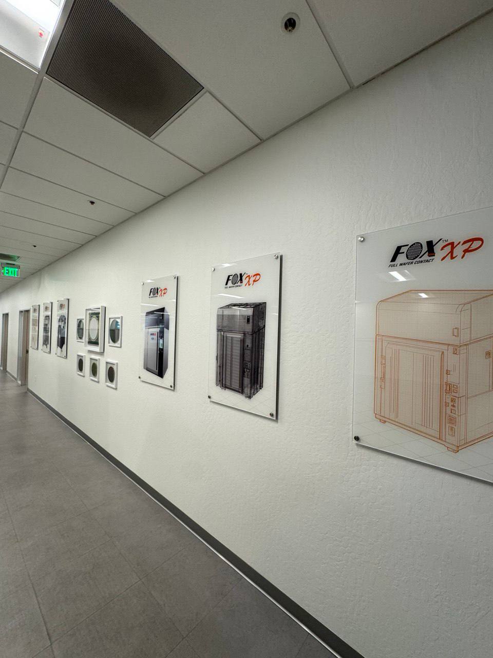 Acrylic product display panels mounted along an office hallway