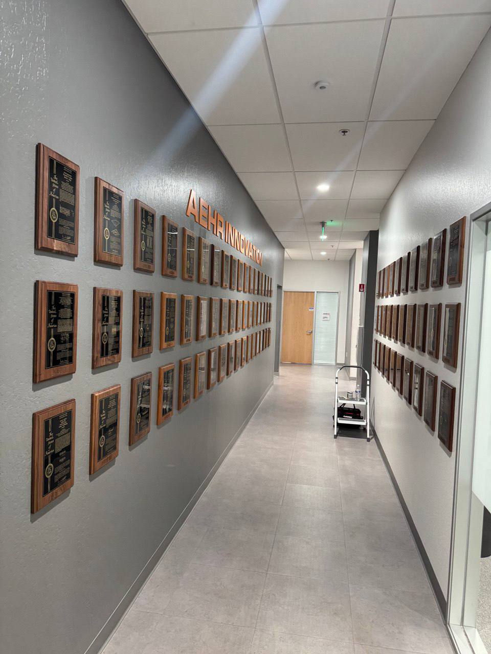 Office hallway lined with mounted patent plaques